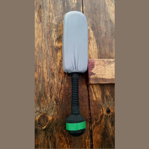 grey foam knife with black handle on wood background
